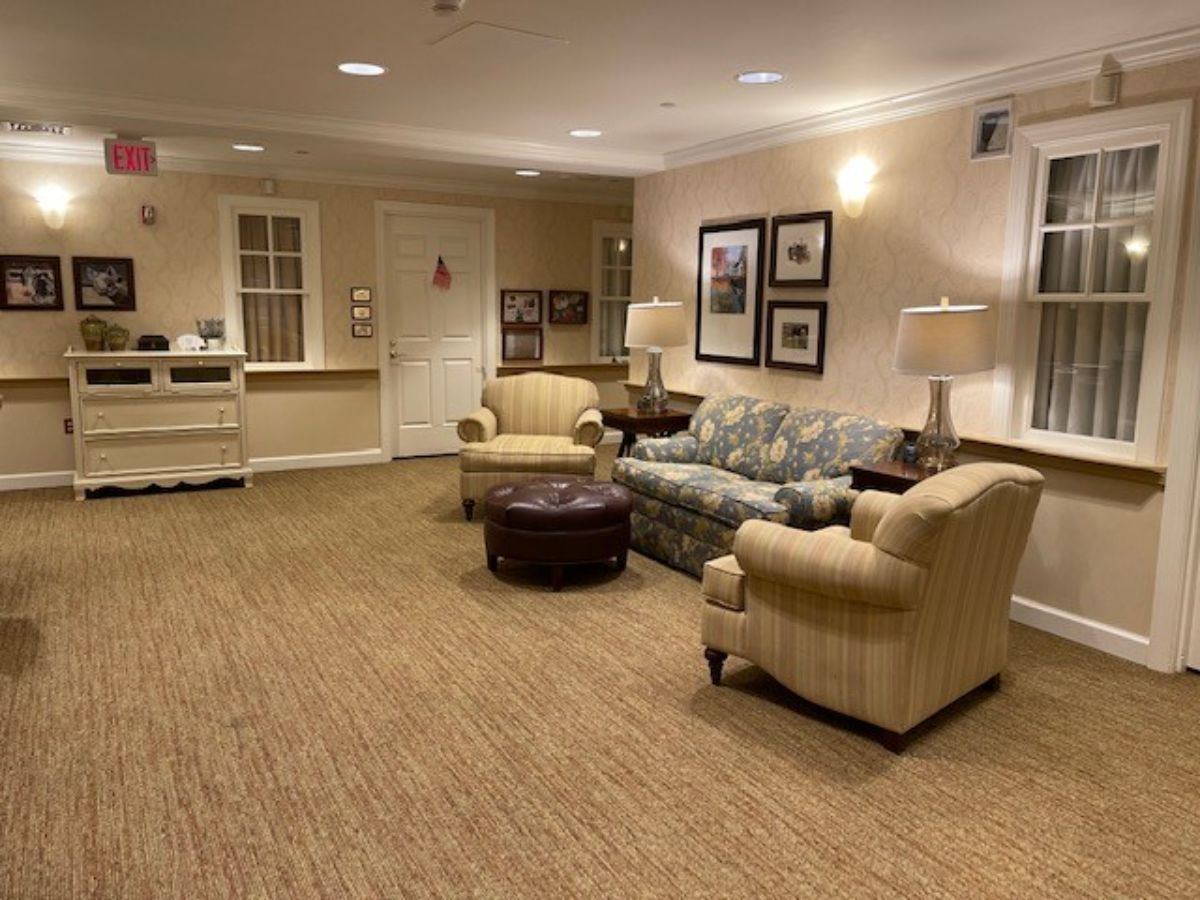 A cozy living room with a sofa, armchairs, and a coffee table.