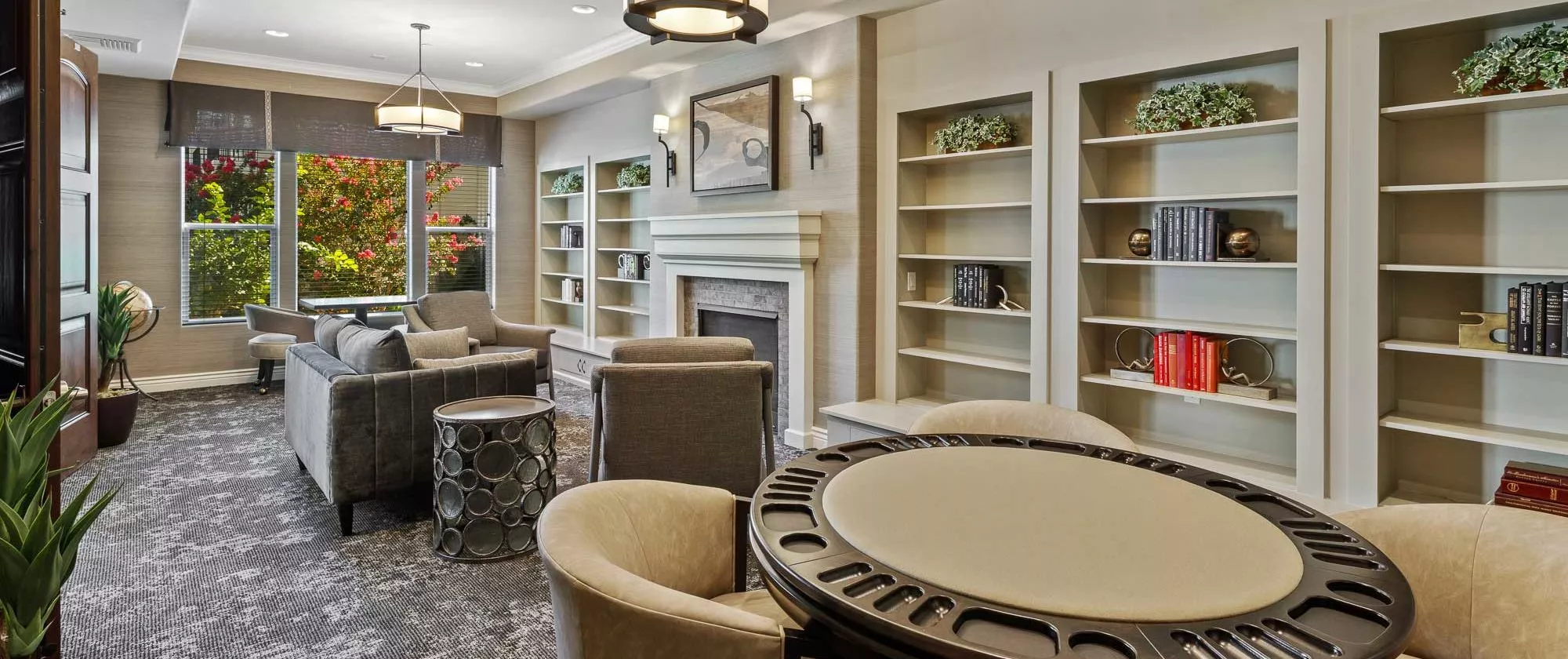 A modern library interior with comfortable seating and a fireplace.
