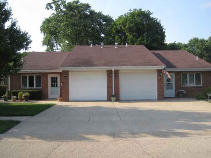 A suburban duplex with attached garages and a shared driveway.