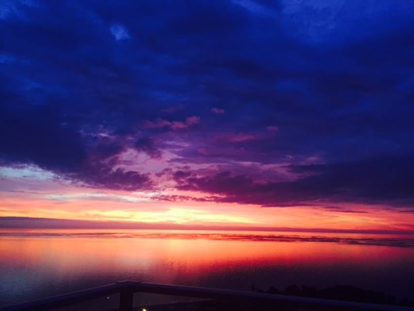 A breathtaking sunset with vibrant colors reflecting on the ocean.