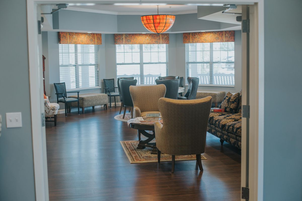 A cozy lounge area with comfortable seating and large windows.
