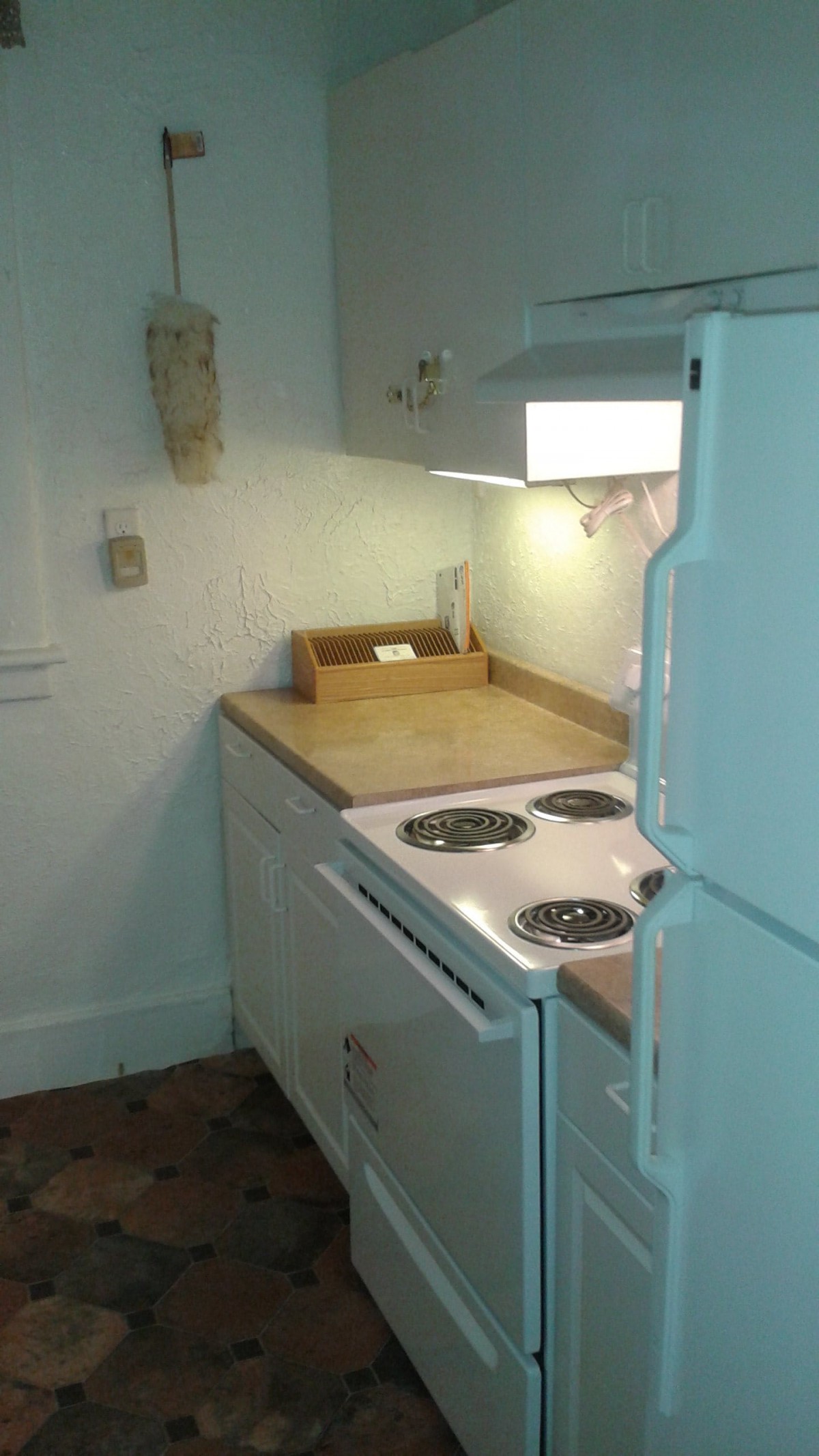 A small kitchen area with a stove and countertop.