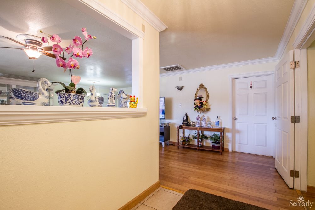 A cozy and well-decorated living space with wooden flooring and stylish decor.