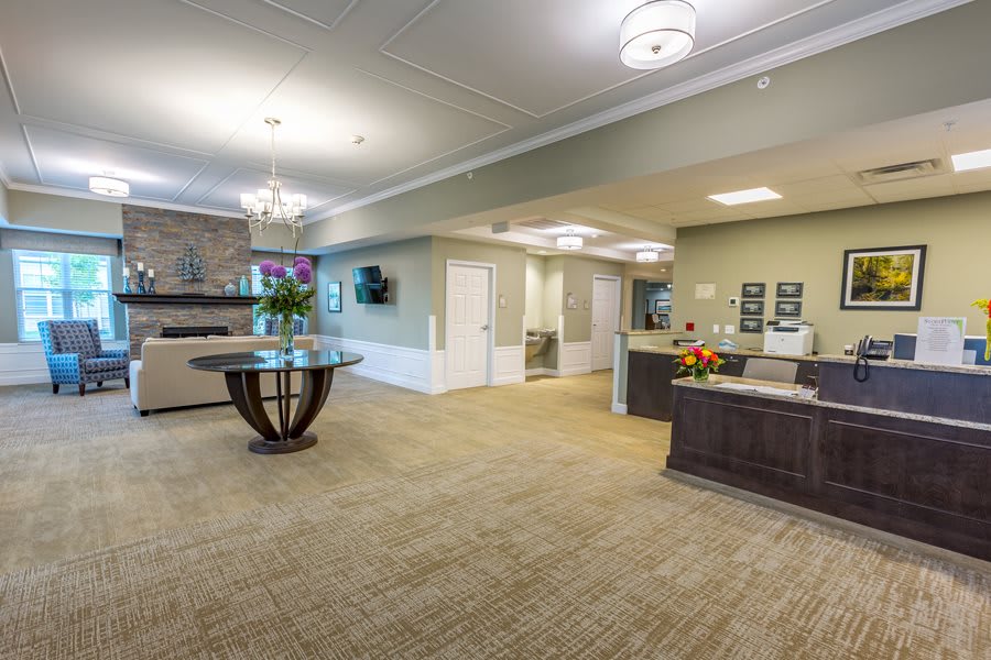 A modern and spacious lobby area with a reception desk and elegant decor.
