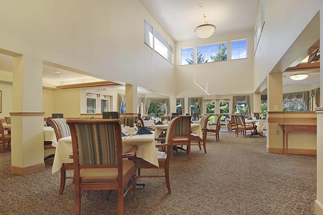 Spacious dining area with elegant seating and large windows.