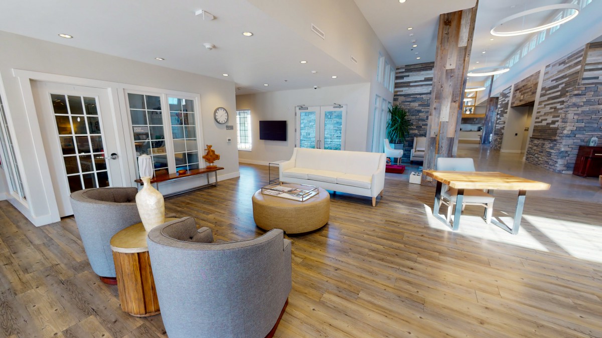 A modern living room with elegant furniture and a wooden floor.