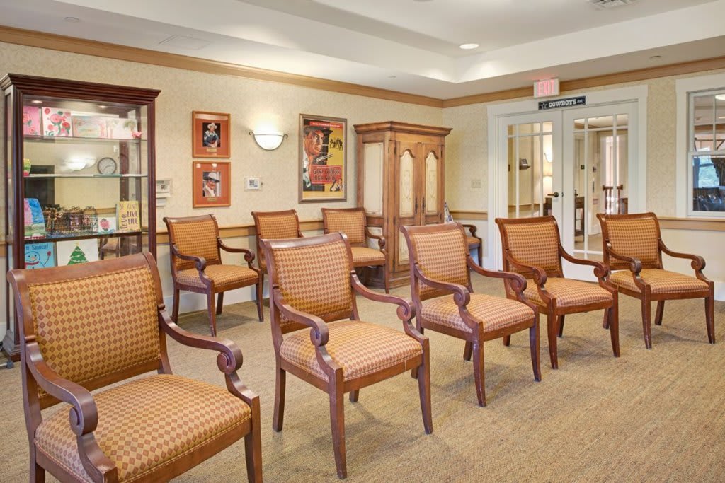 A neatly arranged waiting room with multiple chairs and warm interior decor.