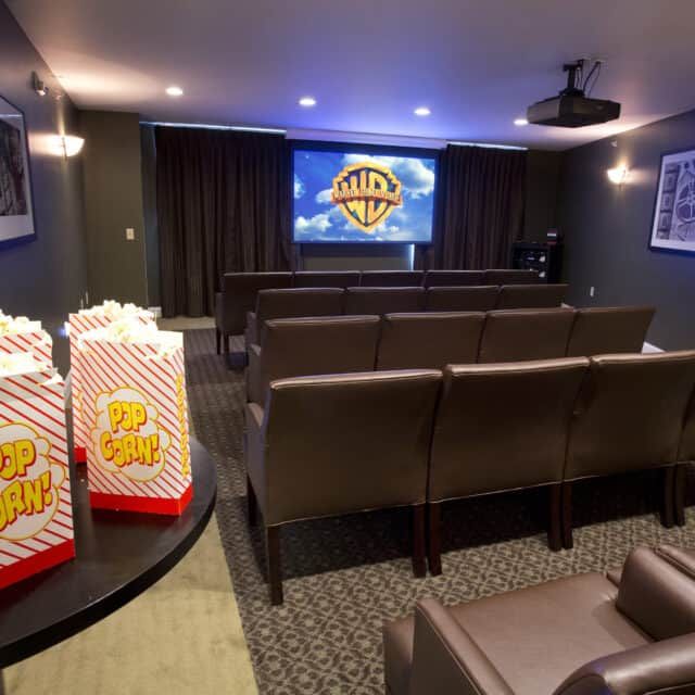 A cozy home theater setup with comfortable seating and popcorn ready for a movie screening.