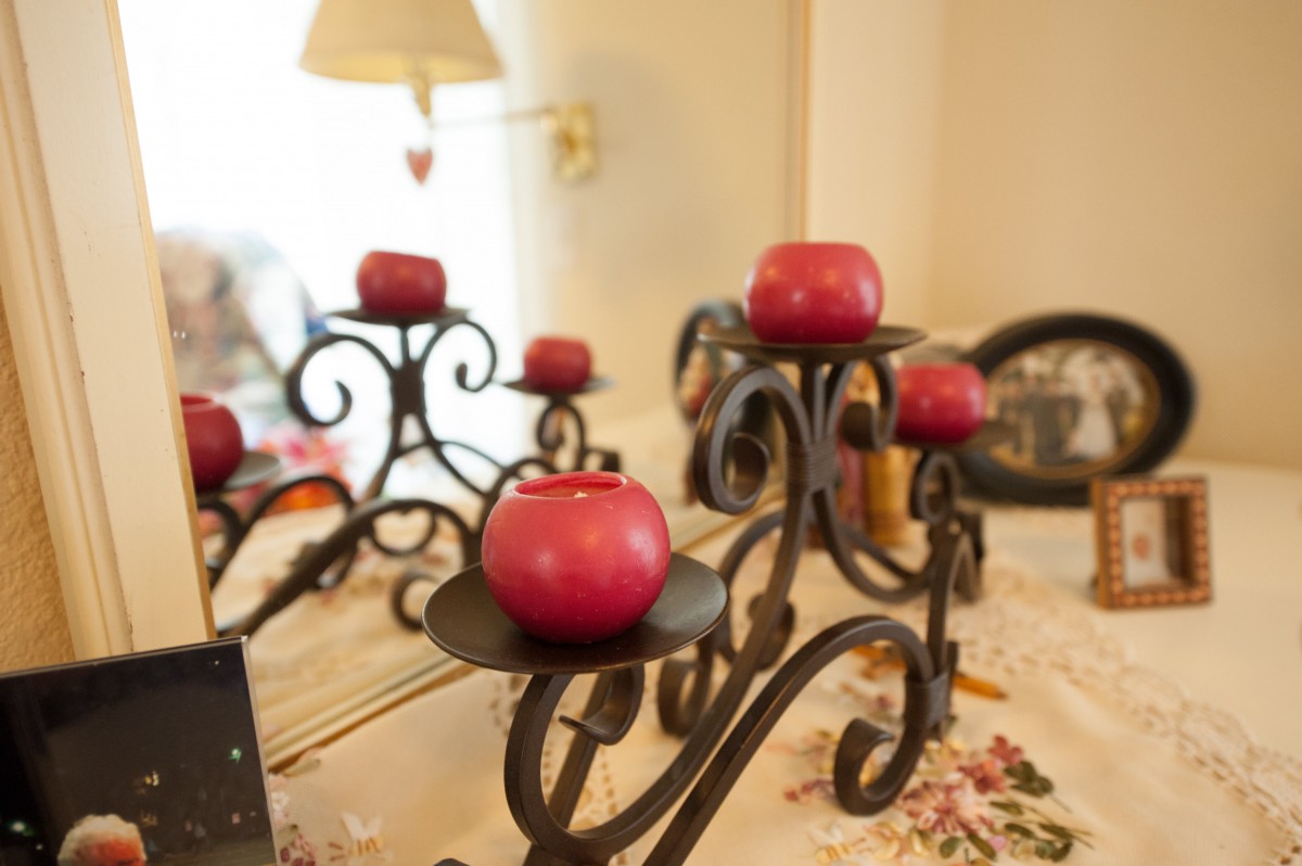 Decorative metal candle holders with red candles set on a table, creating a cozy atmosphere.