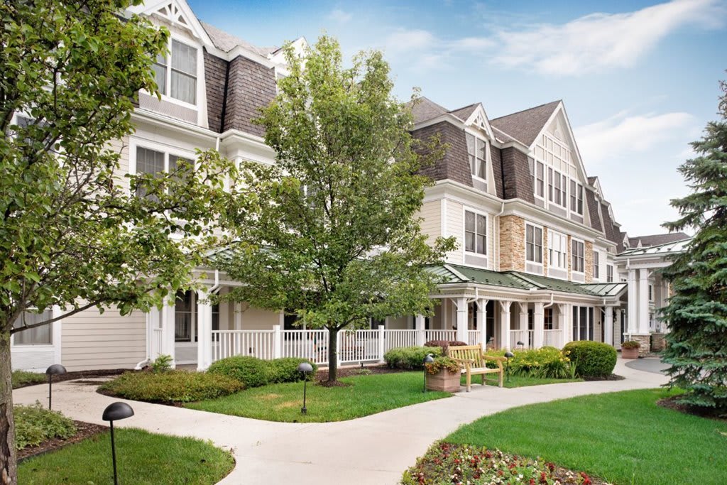 A residential building with a well-maintained garden and pathway.
