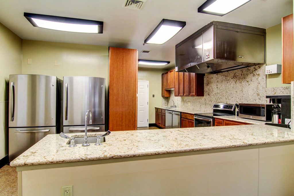 A modern kitchen with stainless steel appliances and wooden cabinets.