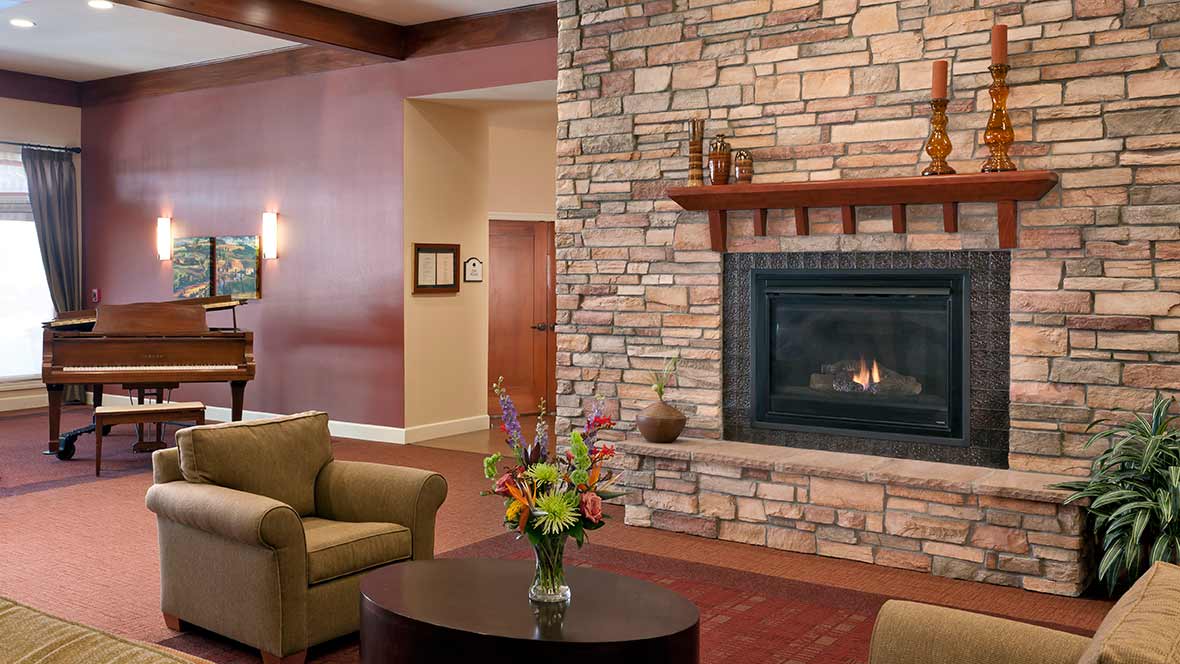 Cozy living room with a stone fireplace and comfortable seating.