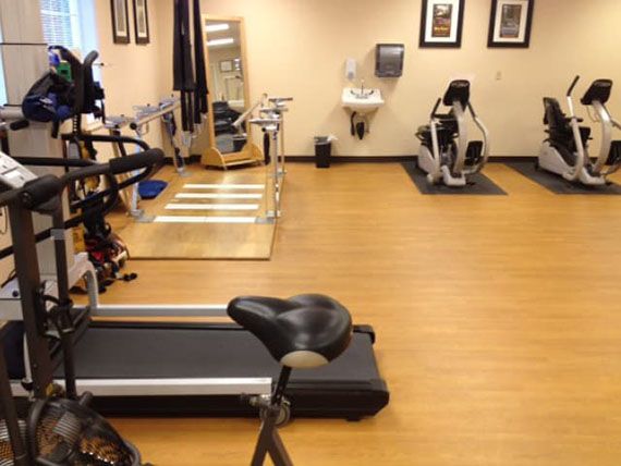 A gym with fitness equipment including a treadmill and stationary bike.