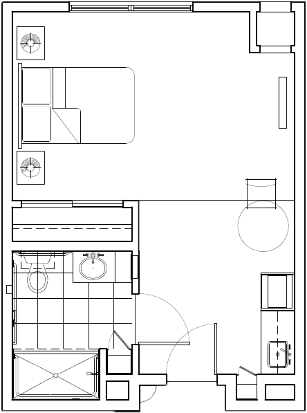A floor plan showing the layout of a small apartment with a bedroom, bathroom, kitchen, and living area.