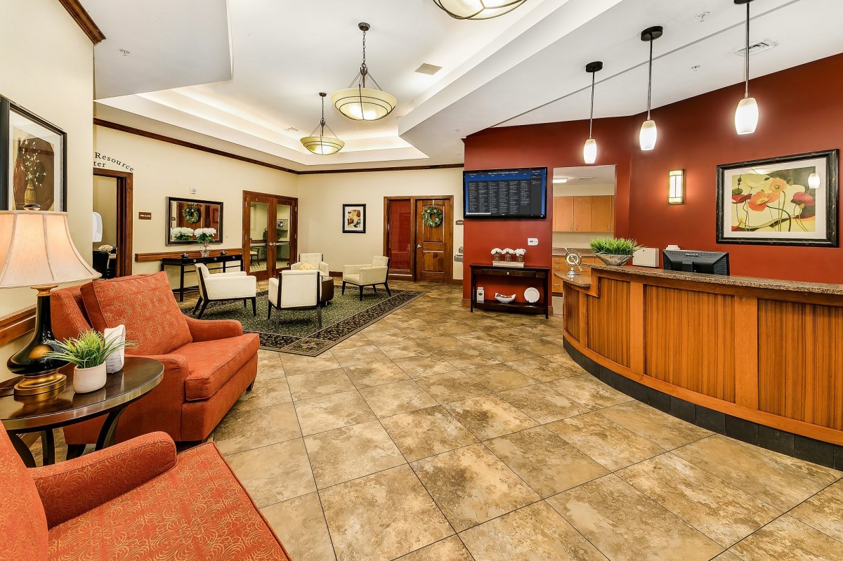 A cozy hotel lobby with comfortable seating and a reception desk.