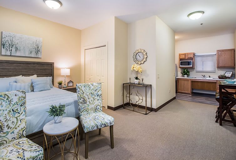 A cozy bedroom featuring elegant furniture and tasteful decor in a modern apartment.