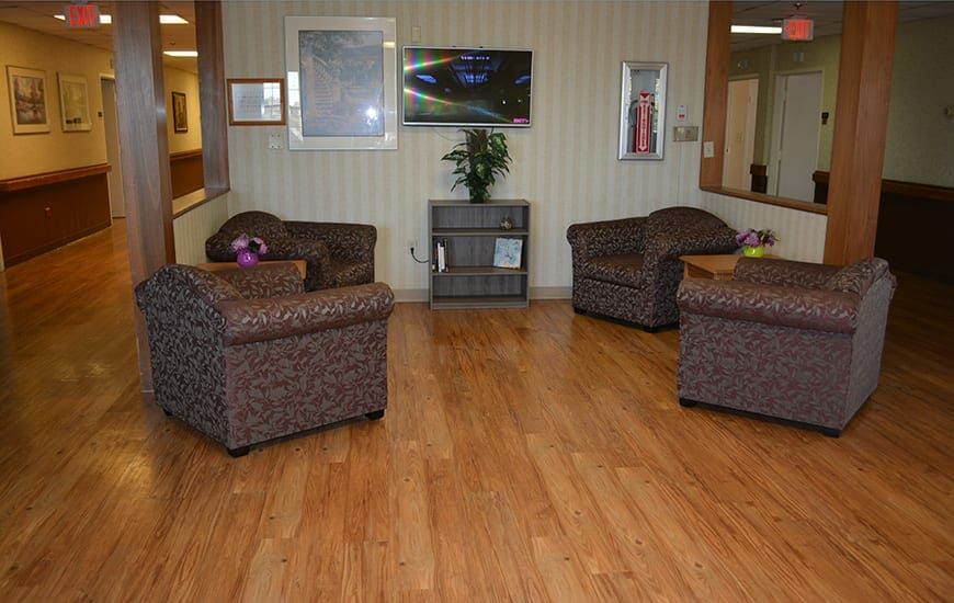 A cozy waiting area with comfortable chairs and artwork on the walls.