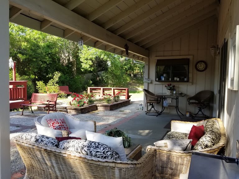 A cozy outdoor patio with comfortable seating and garden views.