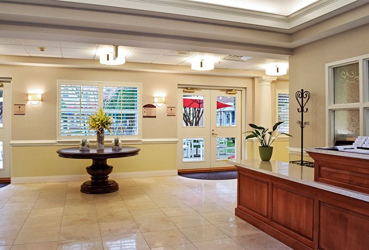 A beautifully decorated lobby area with elegant furniture and floral arrangements.