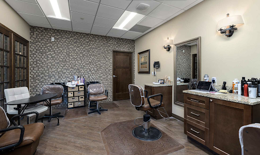 A modern hair salon featuring stylish barber chairs and elegant decor.