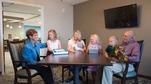 A family gathered around a table having a discussion.