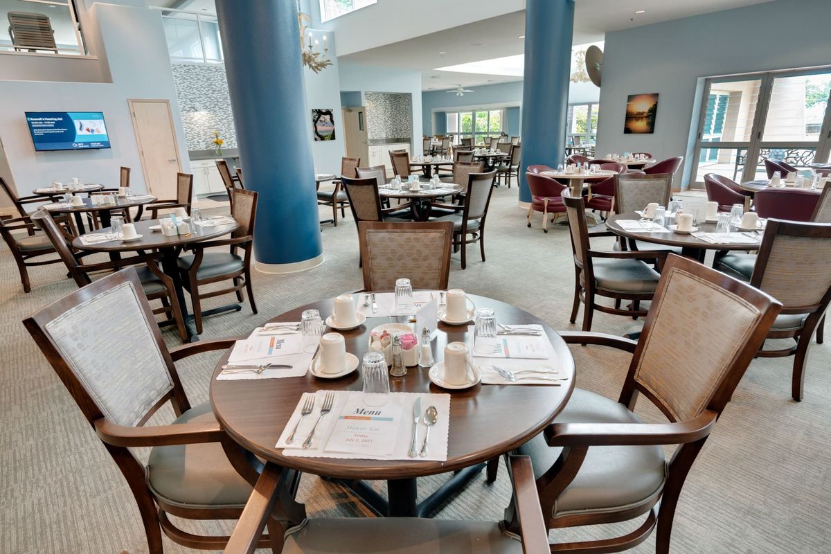 A neatly arranged dining area with tables set for guests.