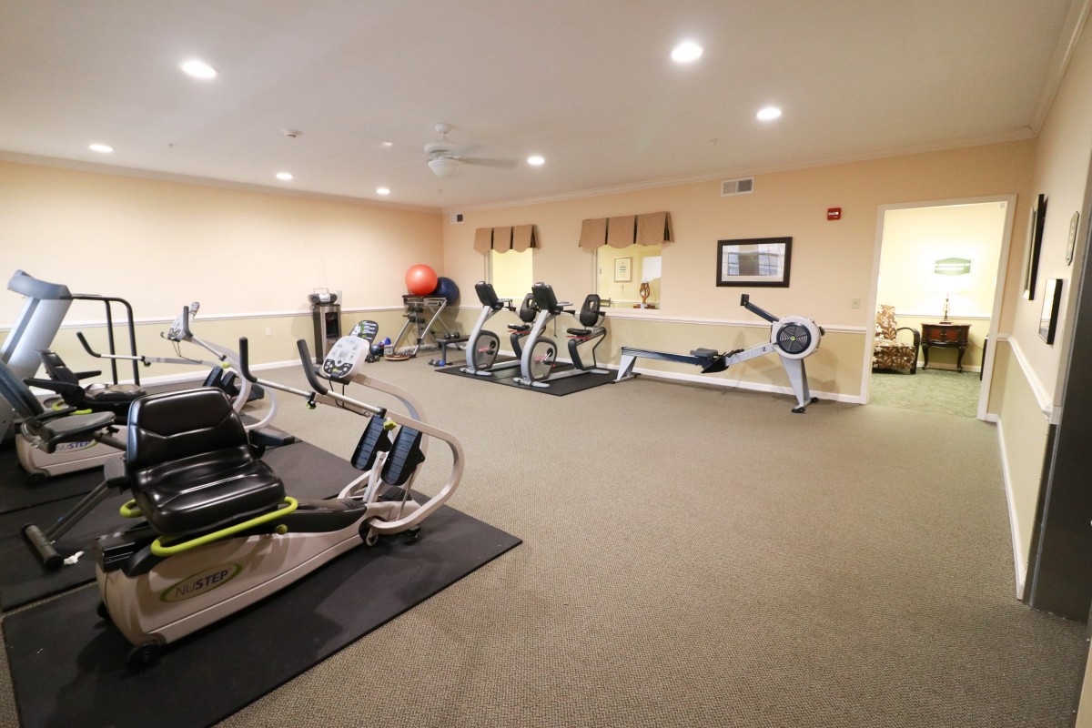 A well-equipped gym with various exercise machines.