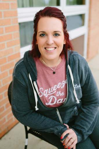 A smiling individual in casual attire enjoying a day outdoors.
