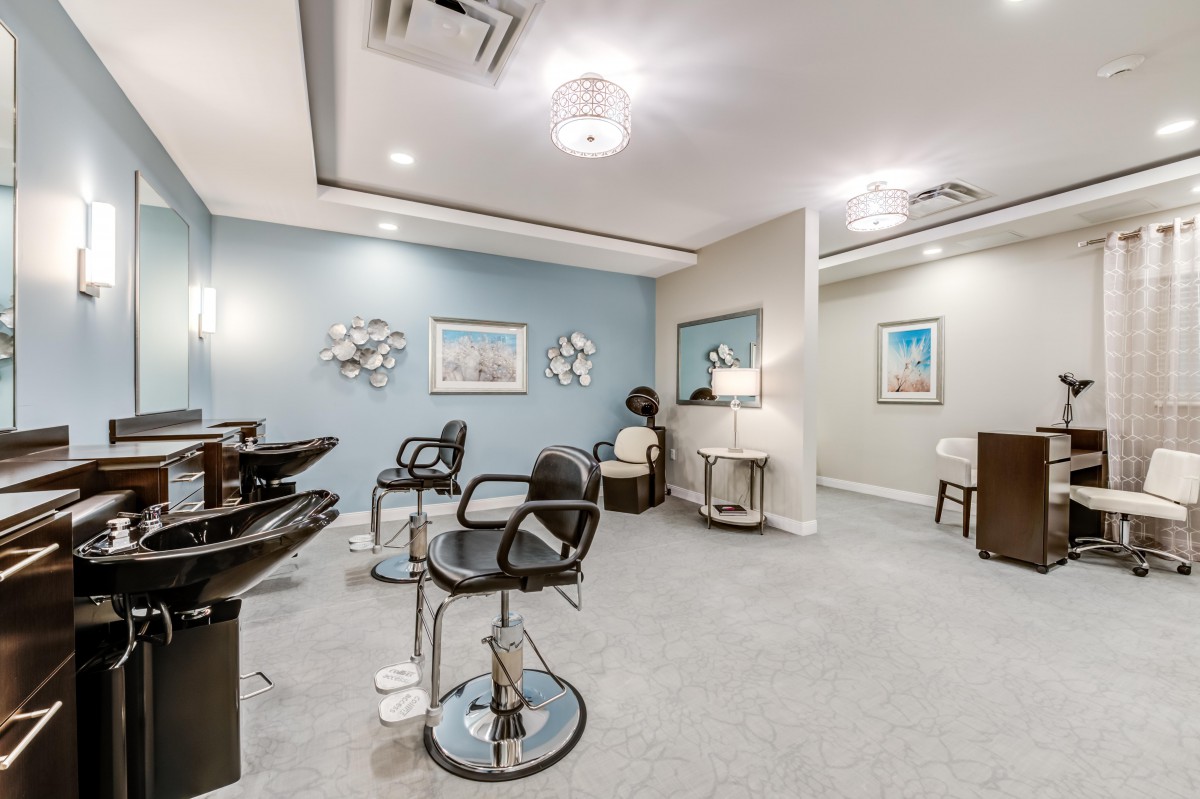 A modern hair salon interior with styling chairs and equipment.