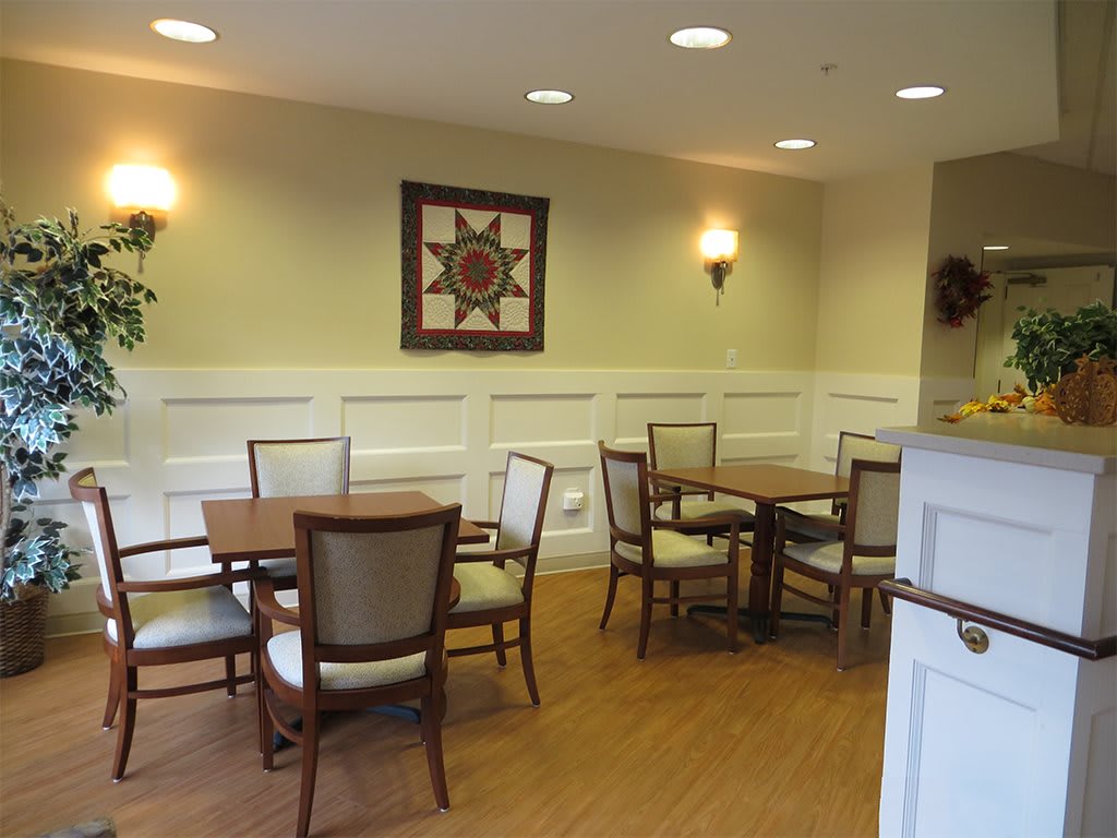 Cozy dining area with tables and chairs, adorned with wall decor.
