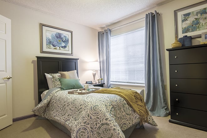 A cozy bedroom with elegant decor and soft lighting.
