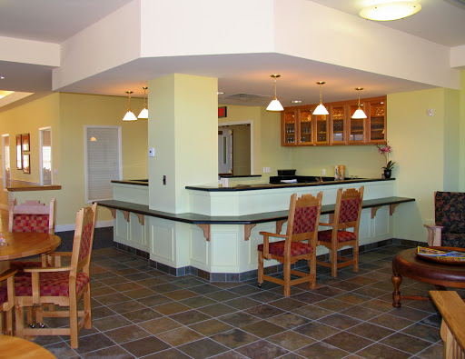 A spacious and modern kitchen bar area with seating, featuring a vibrant color palette and stylish fixtures.