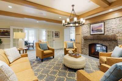 A cozy living room with comfortable seating and a warm fireplace.