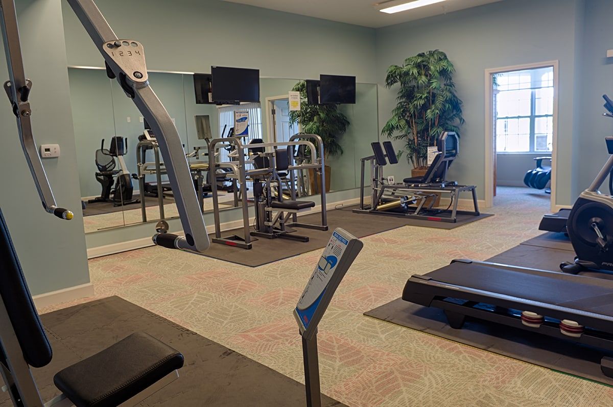 A modern gym with various fitness equipment and exercise machines.
