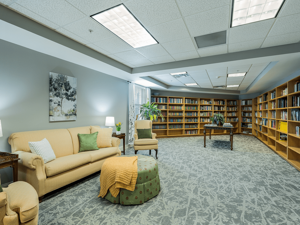 A modern library with comfortable seating and well-organized bookshelves.