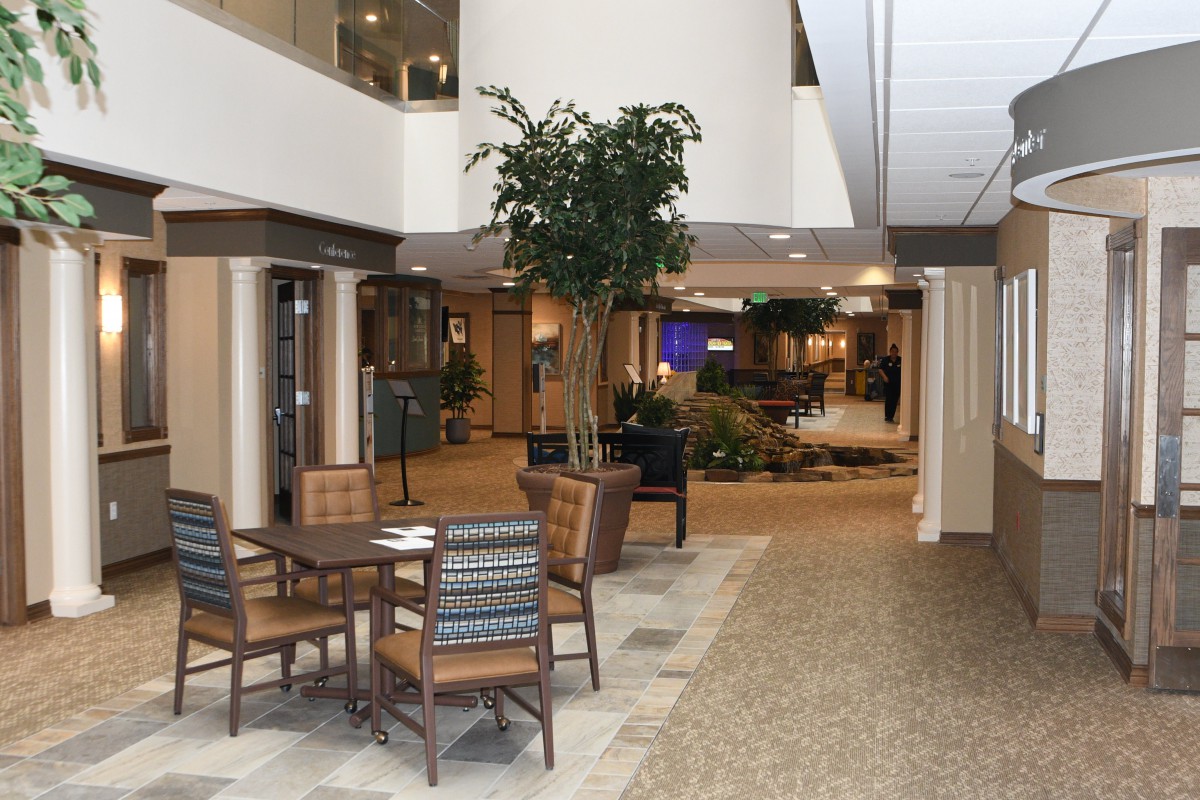 A spacious lobby area with a seating arrangement and indoor plants.