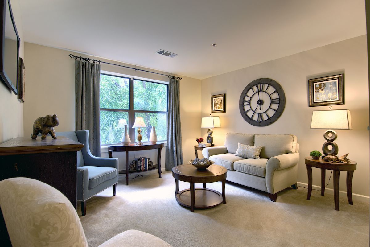 A cozy living room with comfortable seating and decorative elements.