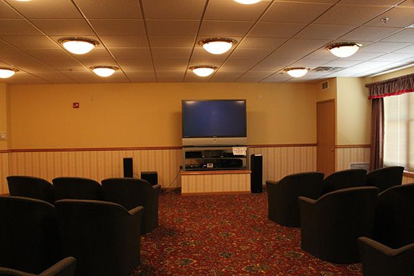 A cozy home theater with comfortable seating and a large screen for entertainment.