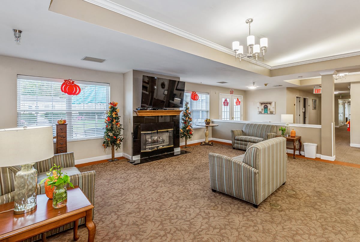 A cozy living room with a fireplace, television, and comfortable seating.