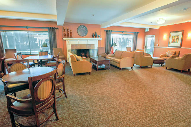 A cozy living room with a fireplace and comfortable seating.