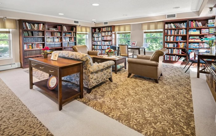 A cozy library space with comfortable seating and abundant natural light.