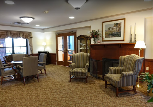 A cozy lounge area featuring striped armchairs and a welcoming atmosphere.