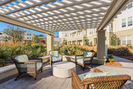 A cozy outdoor seating area under a pergola, perfect for relaxing and enjoying the surroundings.