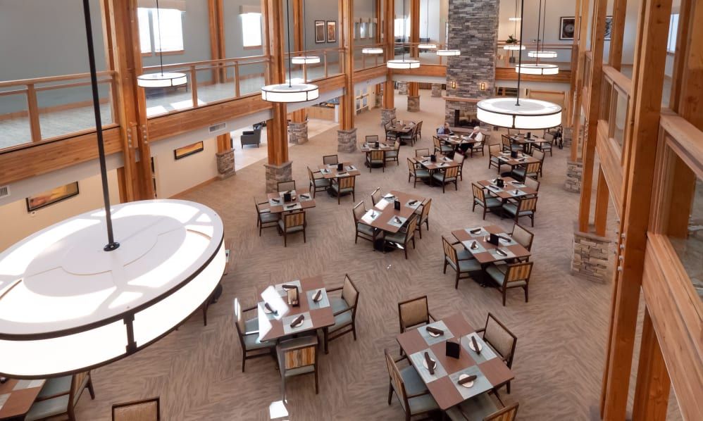 A spacious and modern restaurant interior with neatly arranged tables and chairs.