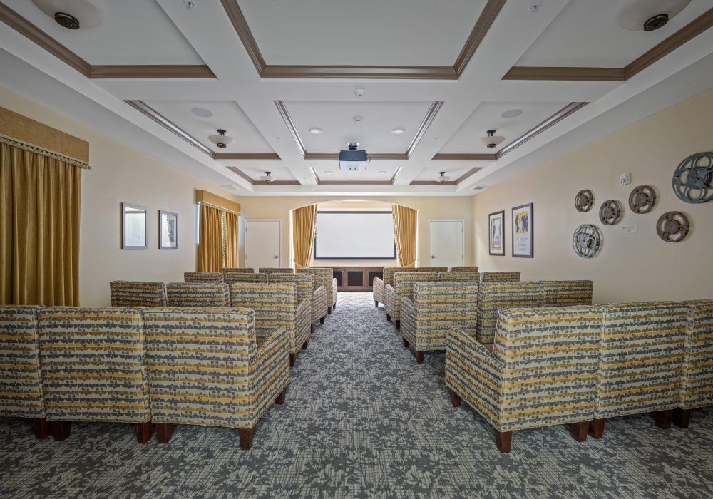 A well-designed conference room with comfortable seating and a projector for presentations.