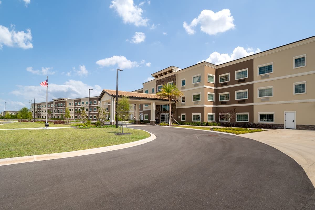 A modern residential apartment building with well-maintained landscaping.