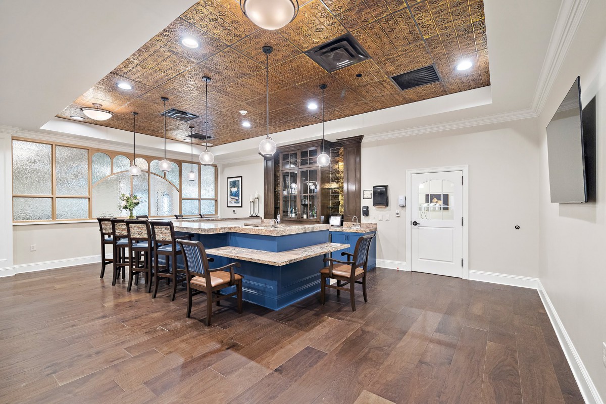 A modern kitchen with an island counter and stylish lighting.