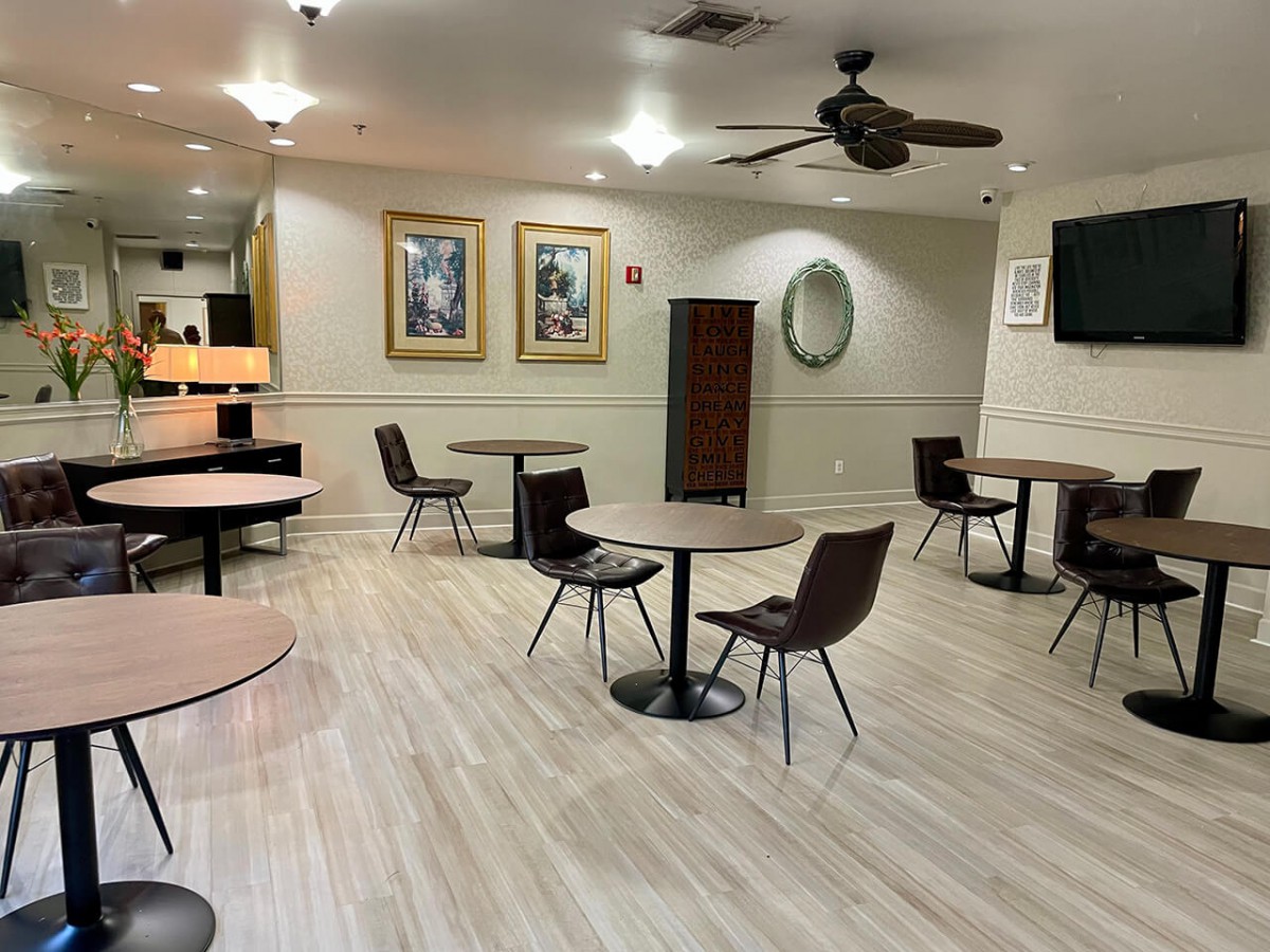 An empty modern restaurant interior with tables and chairs neatly arranged.
