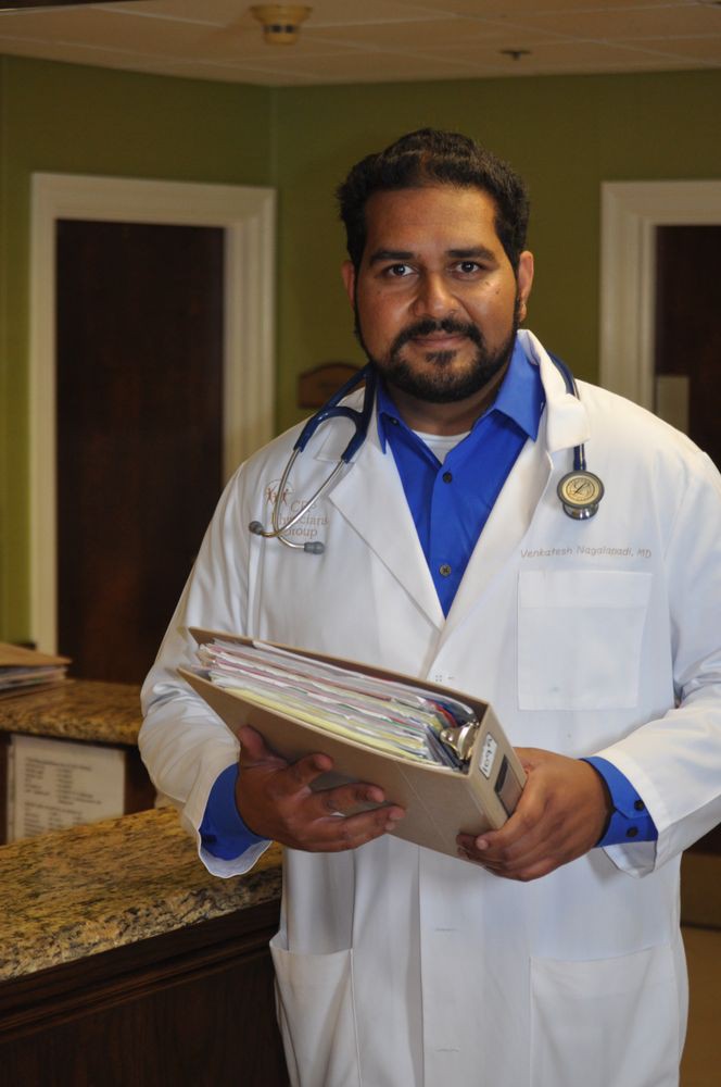 A doctor holding a clipboard, wearing a white coat and stethoscope.