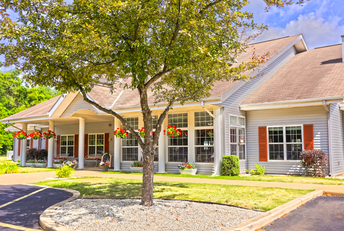 A charming suburban house with a well-maintained front yard and landscaping.